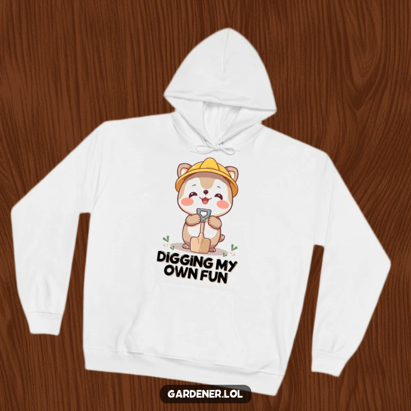 Funny hoodie depicting a cheerful character balancing a small shovel on its nose, a fun balancing act.
