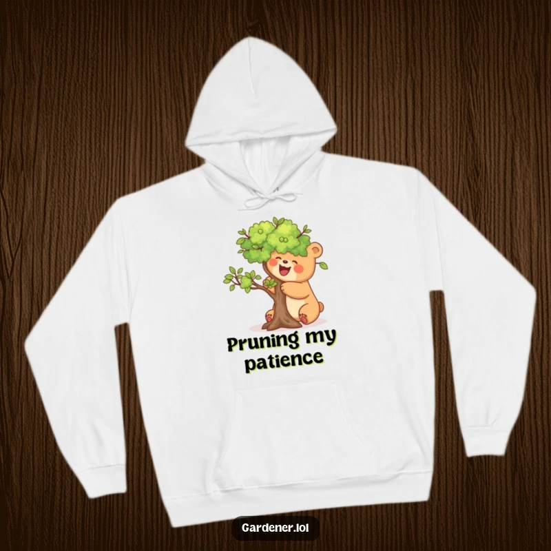 Funny hoodie featuring a joyful bear meticulously pruning a miniature tree, perfect for cozy, humorous downtime.